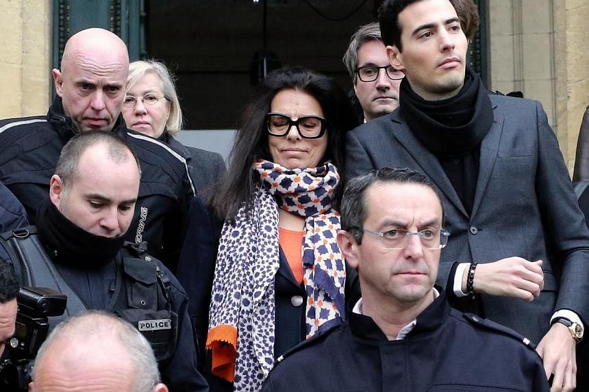Ms Francoise Bettencourt Meyers, daughter of France's richest woman, L'Oreal heiress Liliane Bettencourt, and her son, Jean-Victor (with black scarf), leaving the court with the family lawyers on Jan 26, 2015. -- PHOTO: AFP