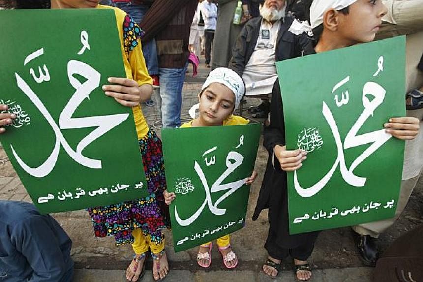 Child supporters of Pakistan's political and religious party Jama'at e Islami hold signs that read "Mohammad" in a protest against satirical French weekly newspaper Charlie Hebdo, which featured a cartoon of the Prophet Mohammad as the cover of its f