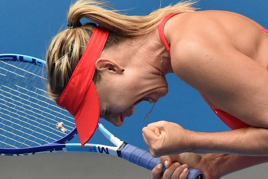 Russia's Maria Sharapova celebrates after defeating Canada's Eugenie Bouchard in their women's singles match on day nine of the 2015 Australian Open tennis tournament in Melbourne on Jan 27, 2015. -- PHOTO: AFP
