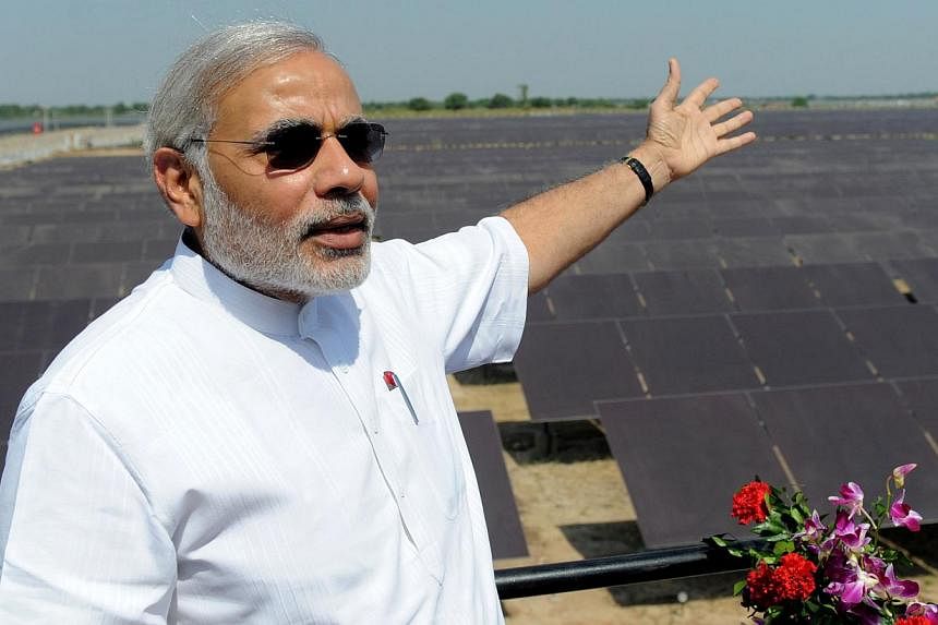 Then chief minister of the western Indian state of Gujarat Narendra Modi gesturing as he poses in this file photograph taken on Oct 14, 2011,&nbsp;at the inauguration of a solar farm in the village of Gunthawada, Banaskantha district. -- &nbsp;PHOTO: