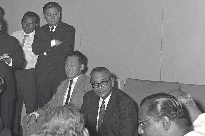 Tengku Abdul Rahman (seated, centre) giving a press conference on talks on Malaysia in 1962. Singapore's then prime minister Lee Kuan&nbsp;Yew is seated on the left. -- PHOTO: ST FILE&nbsp;