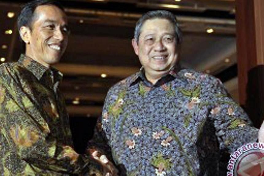 Indonesian President Joko Widodo (left) shaking hands with then outgoing president Bambang Susilo Yudhoyono on Sept 3, 2014. Dr Yudhoyono and other critics say that Mr Joko has yet to enact tough policies on law enforcement, corruption and bureaucrat