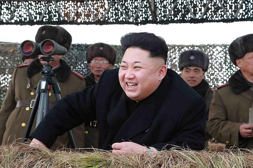 North Korean leader Kim Jong Un watching a winter river-crossing attack drill of the armoured infantry sub-units of the motorised strike group in the western sector of the front of the Korean People's Army in this undated photo released by North Kore