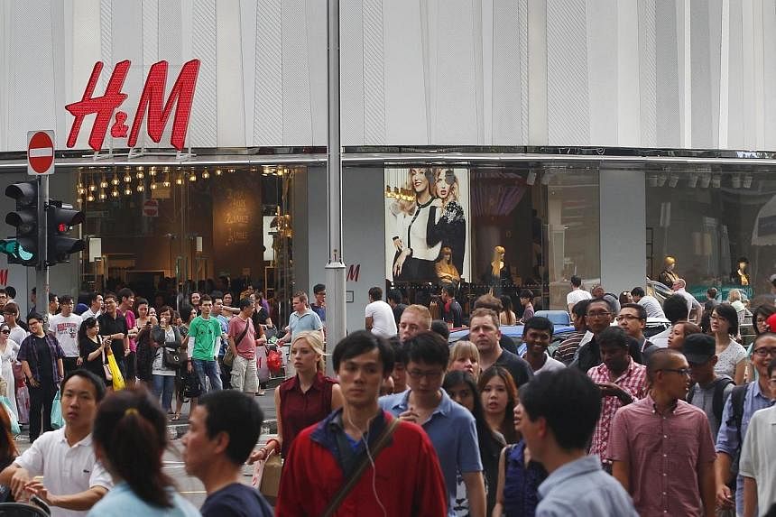 Swedish fashion giant H&amp;M said on Wednesday net profits for 2014 rose almost a fifth and pledged to speed up its global expansion. -- PHOTO: ST FILE