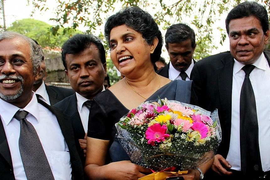 Sri Lanka's former chief justice Shirani Bandaranayake (centre) is greeted by lawyers at the Supreme Court complex in Colombo on Jan 28, 2015, after new Sri Lankan President Maithripala Sirisena reinstated her, saying that her controversial sacking b