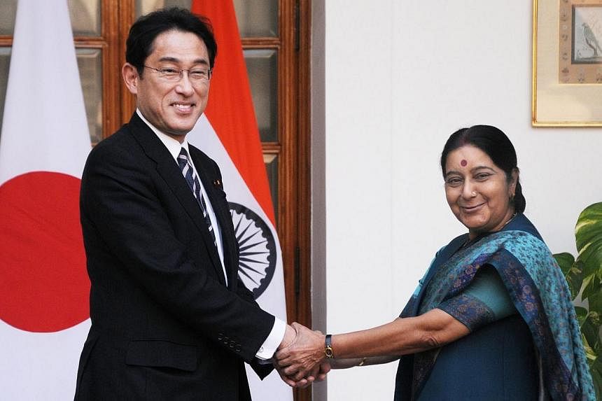 Japanese Minister of Foreign Affairs Fumio Kishida (left)&nbsp;shaking hands with Indian Foreign Minister Sushma Swaraj prior to a meeting in New Delhi, on Jan 17 2015. -- PHOTO: EPA