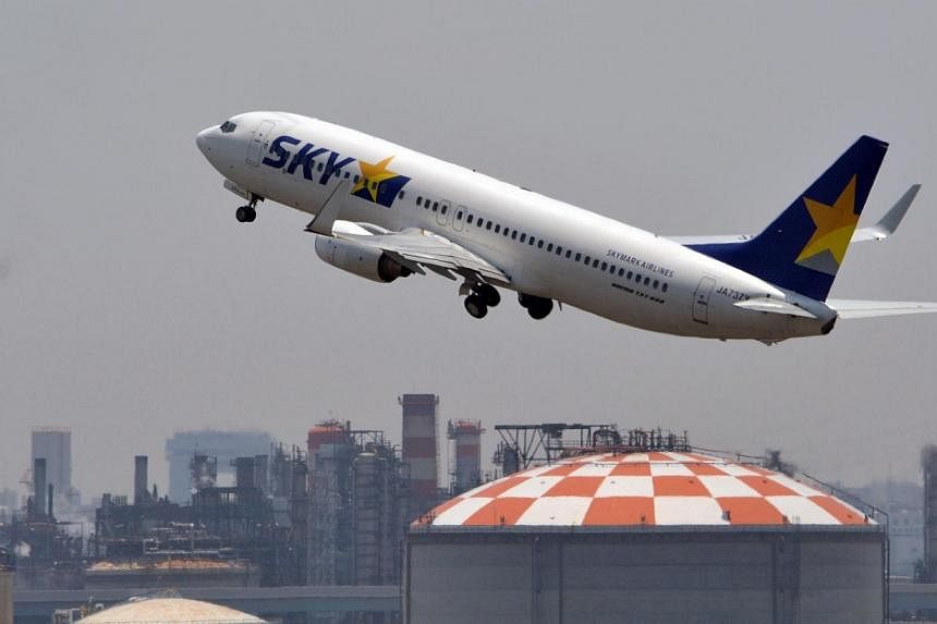 This file picture taken on July 30, 2014 shows a Skymark Airlines plane at Tokyo's Haneda airport.&nbsp;Japanese discount airline Skymark Airlines Inc is preparing to file for bankruptcy protection from creditors under Japan's Corporate Reorganisatio