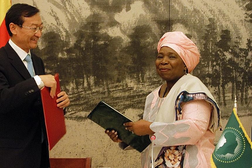 African Union Commission chairman Nkosazana Dlamini-Zuma (right), and Chinese Vice-Foreign Minister Zhang Ming exchange memorandums of understanding on Jan 27, 2015, on a continent-wide infrastructure deal in Addis Ababa.&nbsp;China offered a spirite