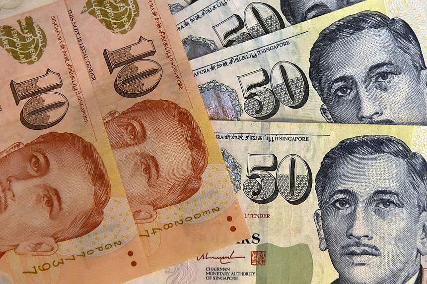 The Singapore dollar on Wednesday hit its weakest in nearly four and a half years, driving losses among emerging Asian currencies, as regional central banks may follow the city-state's unexpected monetary policy easing to tackle deflation. -- PHOTO: 