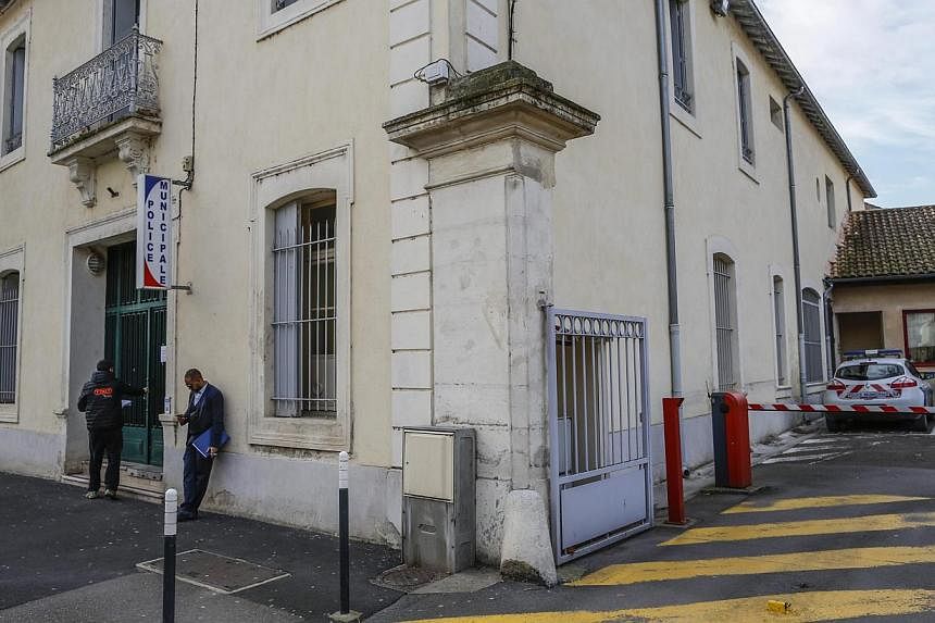 People standing outside the police station in the centre of Lunel, southern France, on Jan 27, 2015. -- PHOTO: EPA