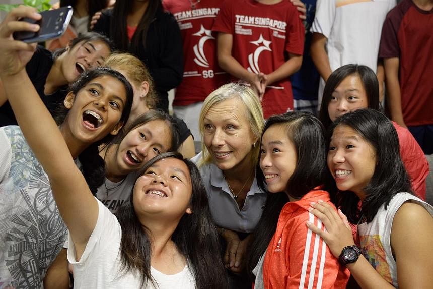 Izabella Tan (holding phone), a junior tennis player with RGS takes a selfie with tennis legend Martina Navratilova and other junior tennis players at the Singapore Sports Institute.&nbsp;International Tennis Hall of Famer Martina Navratilova will re