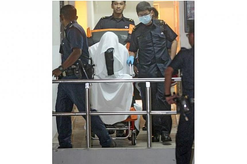 A 26 year-old man was arrested in his home on Thursday morning after an hour-long standoff with police and Singapore Civil Defence Force (SCDF) officers.&nbsp;-- ST PHOTO: SHIN MIN