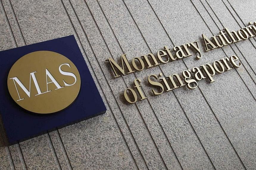 After the 8am announcement by the Monetary Authority of Singapore (MAS), the Singdollar slid as much as 1.1 per cent against the greenback yesterday. -- PHOTO: REUTERS