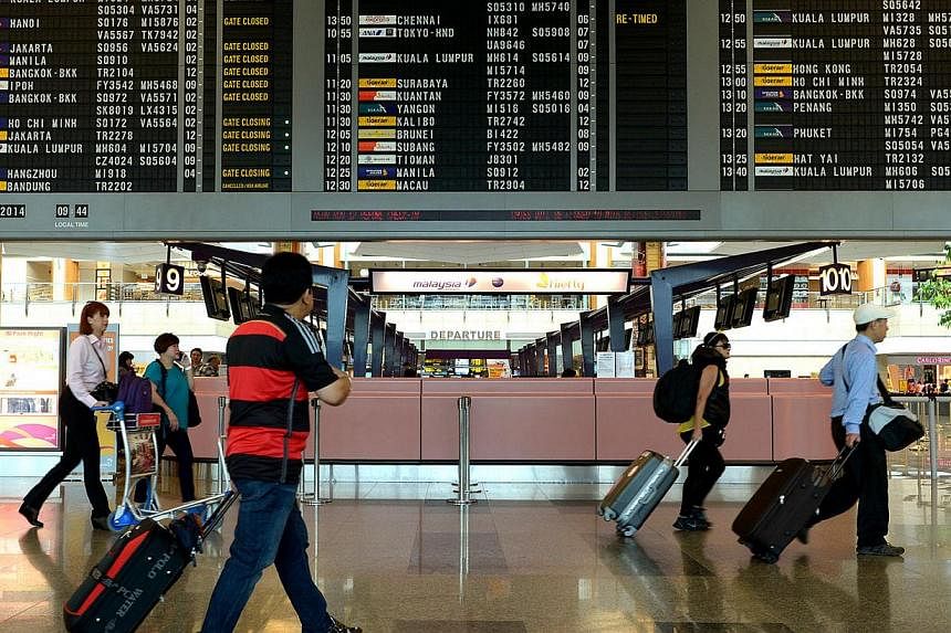 Changi Airport handled a record 54.1 million passengers last year, the highest in over three decades. -- PHOTO: ST FILE