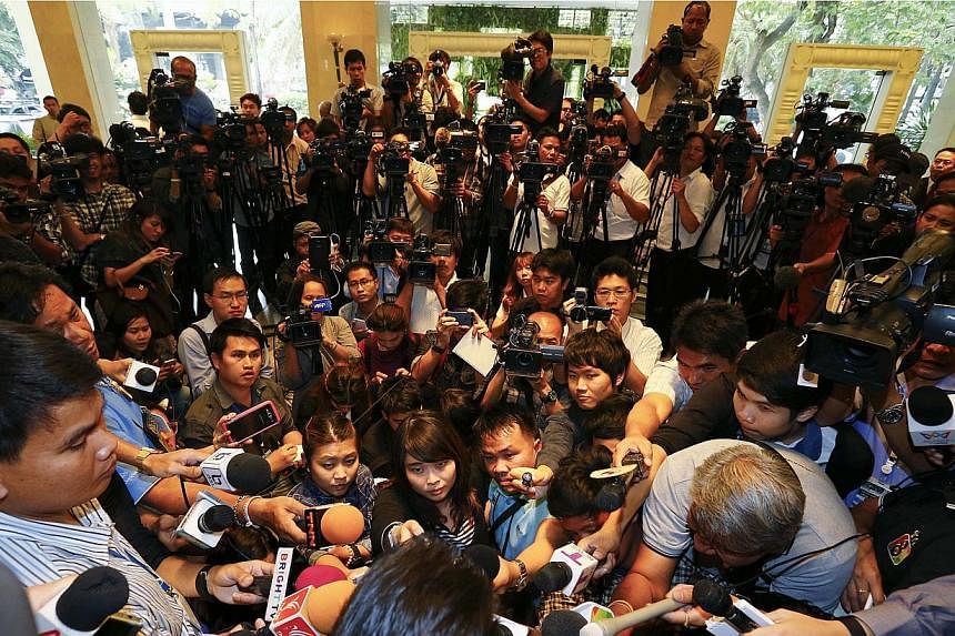 Reporters listening to the Pheu Thai party's legal team making an announcement about ousted prime minister Yingluck Shinawatra, in Bangkok on Jan 23, 2015.&nbsp;A briefing in Thailand by a German rights group on the health of the kingdom's media land