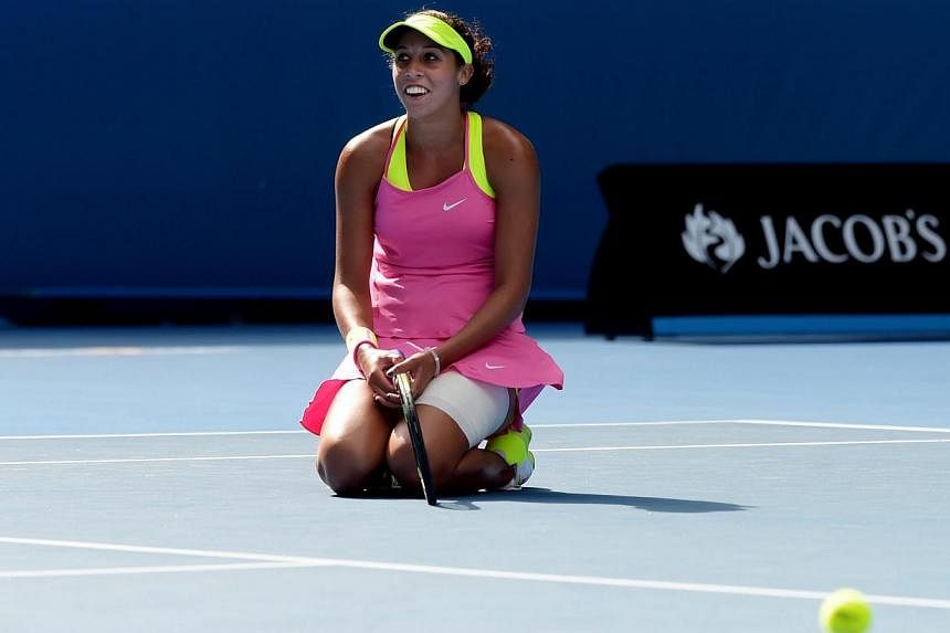 Madison Keys of the USA kneels on the ground as she plays against Serena Williams of the USA during their semifinals match at the Australian Open tennis tournament in Melbourne, Australia, Jan 29, 2015.&nbsp;Making the semi-finals of the Australian O