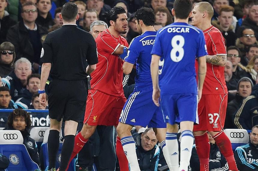 Liverpool's Emre Can (left) has an altercation with Chelsea's Diego Costa (centre) during the English Capital One Cup semi-final soccer match return leg between Chelsea FC and Liverpool FC at Stamford Bridge in London, Britain, 27 Jan 2015. -- PHOTO: