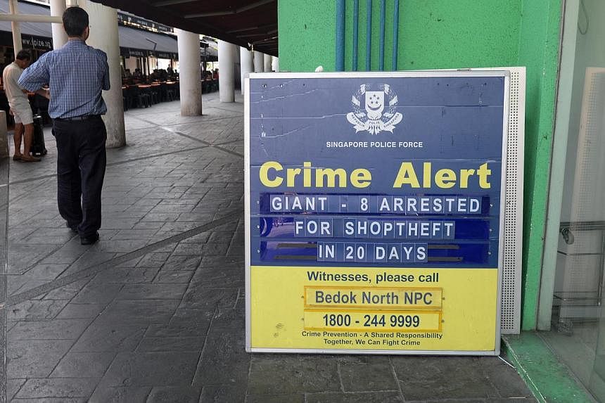 A crime alert sign put up by Neighbourhood Police Post (NPCCs) just outside Giant supermarket at Bedok Market Place on May 13, 2014. -- ST PHOTO: AZIZ HUSSIN