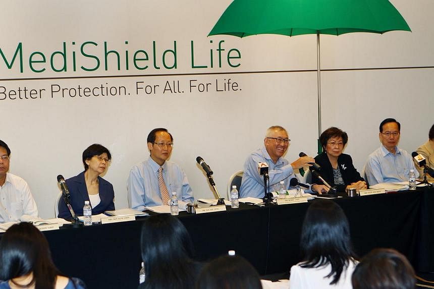 MediShield Life Review Committee chairman Bobby Chin (fourth from left) with members of the committee speaking during a&nbsp;press conference held at the Suntec City Convention Centre on June 27, 2014. &nbsp;-- PHOTO: LIANHE ZAOBAO FILE