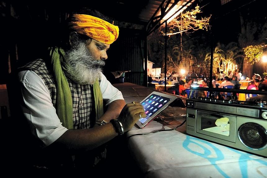 An Indian man listens to Prime Minister Modi's special address via All India Radio in Bangalore, India, on Jan 27, 2015. In a bid to boost domestic manufacturing through its "Make in India" programme, the Narendra Modi government may have taken an in
