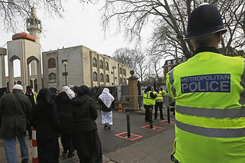 Police carry out a regular patrol as worshippers arrive at the London Central Mosque at Regent's Park in London Jan 9, 2015. British mosques are to throw their doors open to the general public, it was announced on Wednesday, in a bid to reach out to 