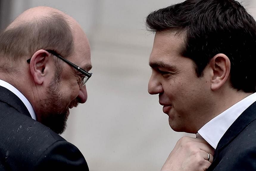 Greek Prime Minister Alexis Tsipras (right) welcomes the European Parliament chairman Martin Schulz before their meeting in Athens on Jan 29, 2015. -- PHOTO: AFP&nbsp;