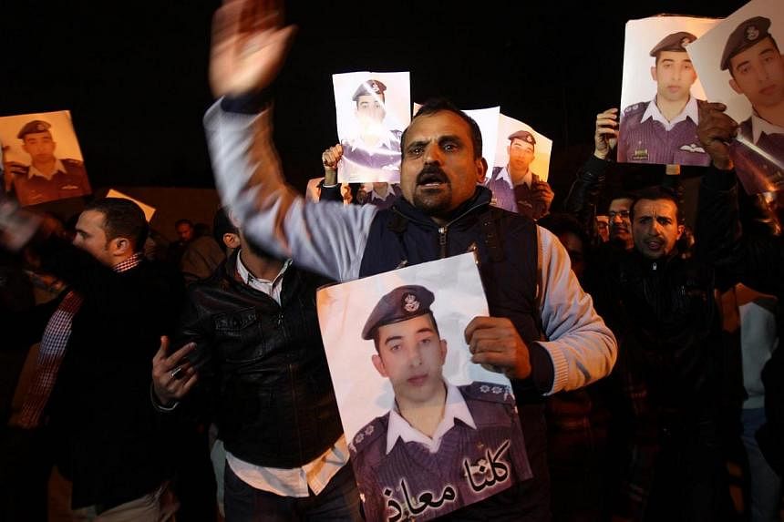 Relatives of Jordanian pilot Muath al-Kasaesbeh, who was captured by Islamic State militants in Syria, protesting in front of Royal palace in Amman, Jordan on Jan 28, 2015. -- PHOTO: EPA