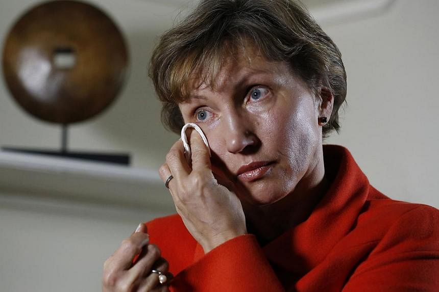 Marina Litvinenko, the wife of former KGB agent Alexander Litvinenko who was murdered in London in 2006 with a rare radioactive isotope, wiping away a tear during an interview in London Jan 21, 2015. -- PHOTO: REUTERS