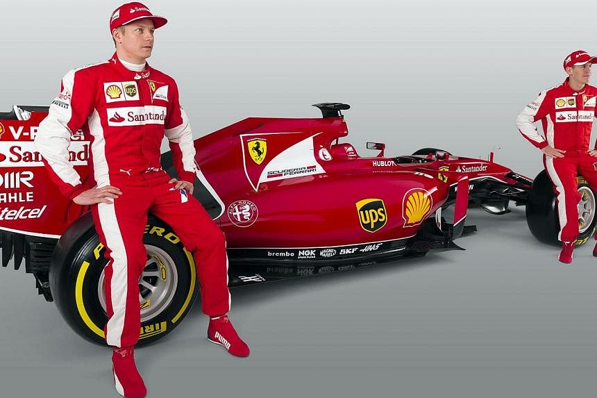 This handout picture released on Jan 30, 2015, by the Ferrari press office shows the new Formula 1 of the team Ferrari, the FS15-T with pilots Kimi Raikkonen (left) and Sebastian Vettel (right) during its launching in Maranello. -- PHOTO: AFP