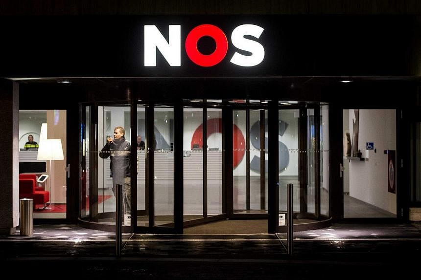 Extra security guards at the entrance of the offices of Dutch television broadcasting organization NOS the morning after an alleged gunman was arrested for disrupting the evening news, at the Media Park in Hilversum, the Netherlands on Jan 30, 2015.&