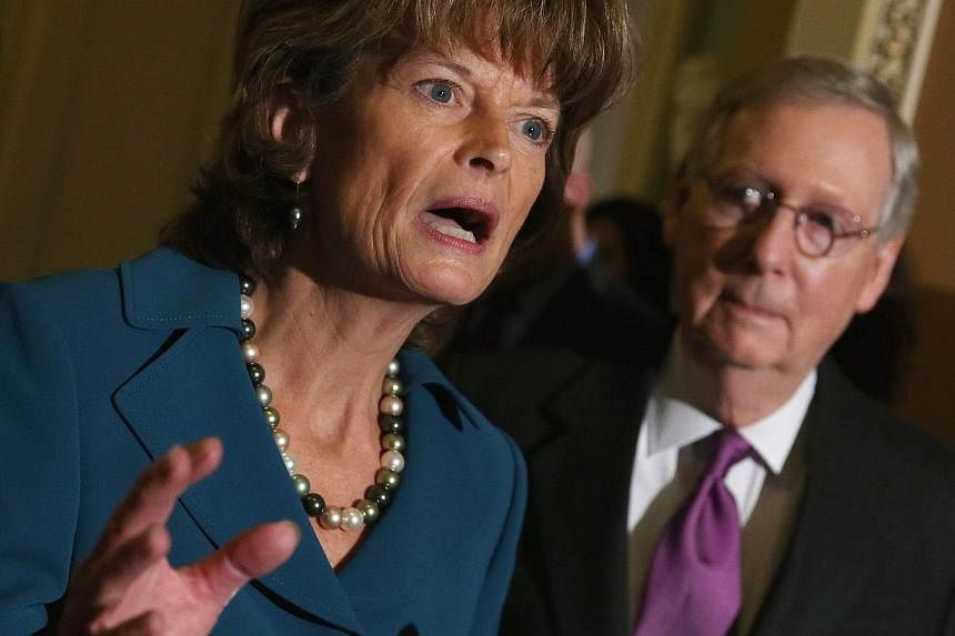 Republican Senator Lisa Murkowski speaks while flanked by Majority Leader Mitch McConnell on Jan 29, 2015 at the US Capitol in Washington, DC. The US Senate on Thursday approved the immediate construction of the controversial Keystone XL oil pipeline