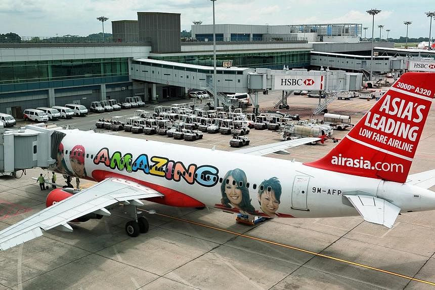 Budget airline AirAsia Bhd resumed online promotions and advertising this week, a month after a plane operated by its Indonesia affiliate crashed into the Java Sea, killing all 162 people on board.&nbsp;An AirAsia aircraft at Changi Airport Terminal 