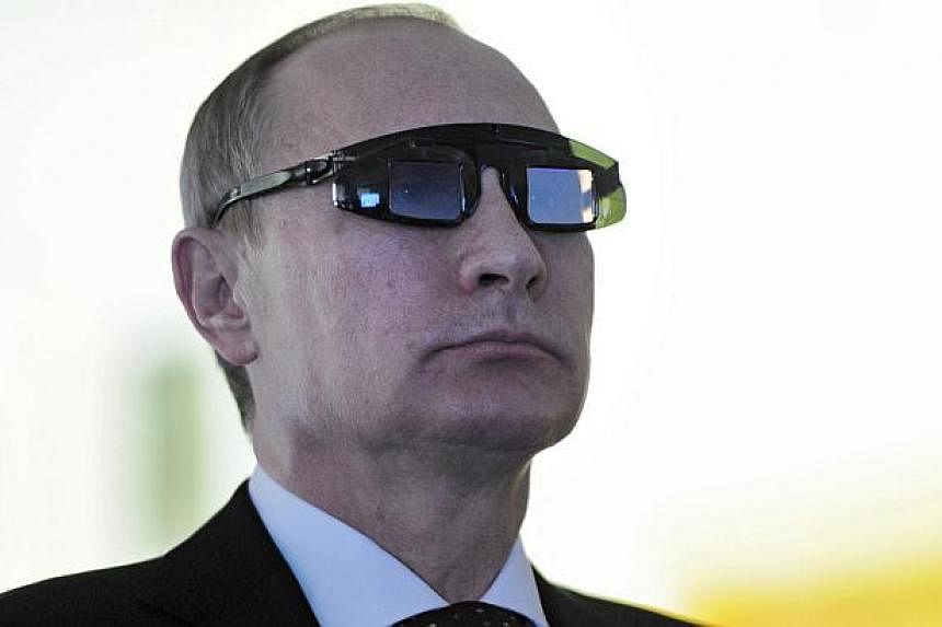 Russian President Vladimir Putin wears special glasses on a laboratory visit in St Petersburg, Russia on Jan 26 2015.&nbsp;One of Vladimir Putin's main opponents may have broken a taboo by publishing what he says is the pseudonym used by one the Russ