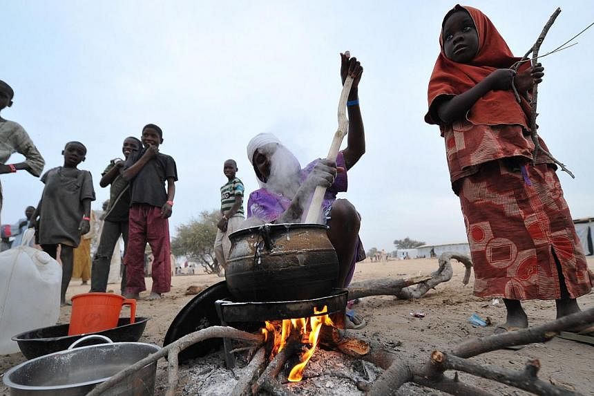 Nigerian refugees prepare food and go about their daily lives at a United Nations High Commission for Refugees camp in Baga Sola on Jan 29, 2015. The refugees arrived in the camp after the attack by Boko Haram millitants in the Nigerian town of Baga.