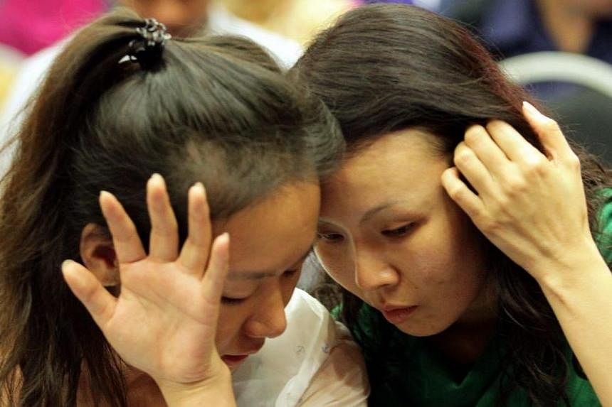 Relatives of a passenger on missing Flight MH370 at the DCA office in Putrajaya. -- PHOTO: THE STAR/ASIA NEWS NETWORK