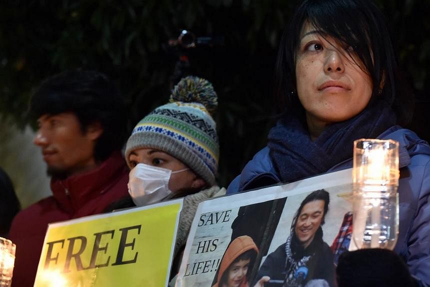 Demonstrators staging a rally to demand the release of Japanese hostage Kenji Goto, who was kidnapped by ISIS, in front of the prime Minister's official residence in Tokyo on Jan 30, 2015. -- PHOTO: REUTERS