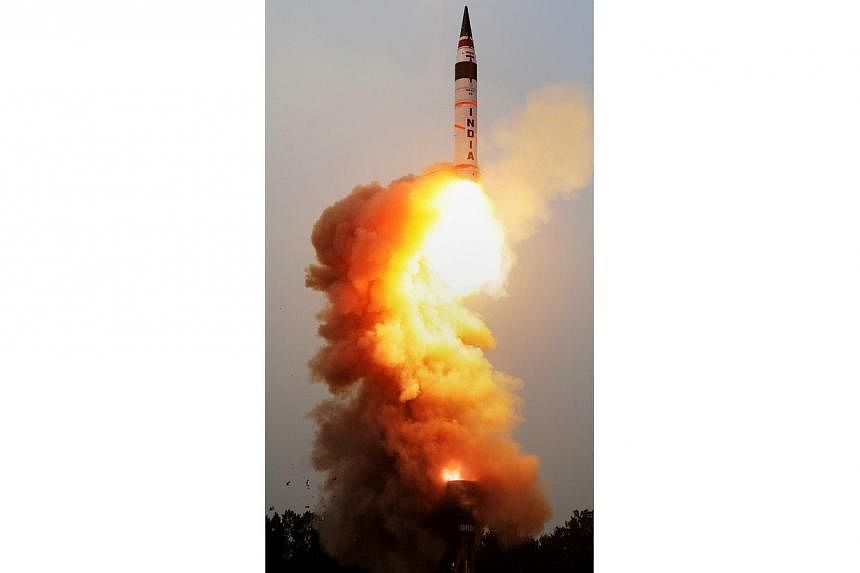 In this handout photograph received from the Defence Research and Development Organisation (DRDO) on Jan 31, 2015, the Agni V blasts off from a canister mounted atop a mobile truck on Wheeler Island, off the eastern state of Orissa.&nbsp;India on Sat