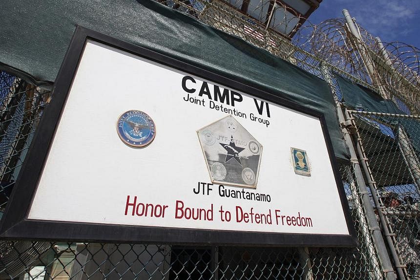 A guard opens the gate at the entrance to Camp VI, a prison used to house detainees at the US Naval Base at Guantanamo Bay, in this file photo taken March 5, 2013. -- PHOTO: REUTERS