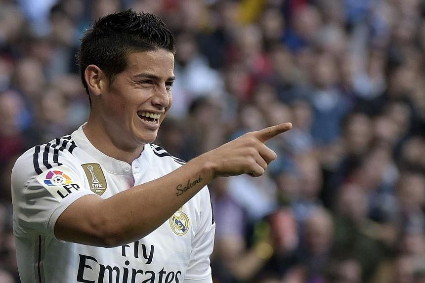 Colombia international footballer James Rodriguez is not just a hit on the terraces at Real Madrid - he has now been voted as the "ideal lover" for legions of besotted Colombian women. -- PHOTO: AFP