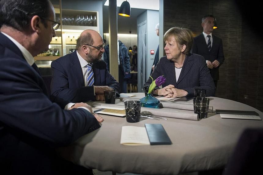 (From left) French President Francois Holland, President of the European Parliament Martin Schulz, and German Chancellor Angela Merkel talk during a meeting in Strasbourg, France, on Jan 30, 2015. -- PHOTO: EPA