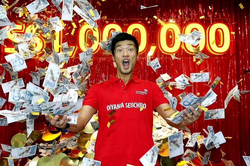 Japanese civil engineer Oiyama Seiichiro, 34, walked away with $1 million after he won Changi Airport's millionaire draw on Sunday, Feb 1, 2015. -- ST PHOTO: CHEW SENG KIM