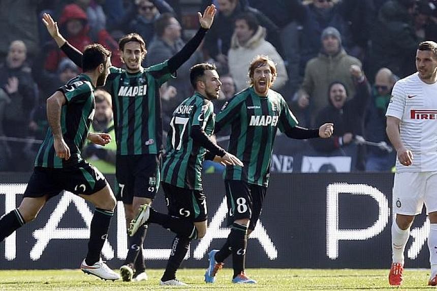 Sassuolo's Nicola Sansone (third, left) celebrates after scoring a goal against Inter Milan during their Italian Serie A soccer match at the Mapei stadium in Reggio Emilia on Feb 1, 2015.&nbsp;Sassuolo defeated Inter Milan 3-1, with both sides finish