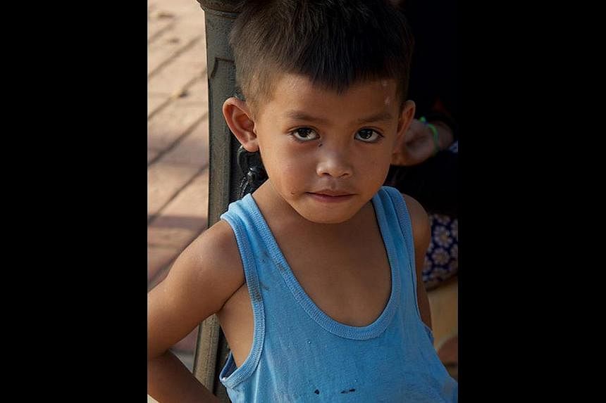 "Frederico", whose real identity is unknown, is seen lying naked on the floor, all skin and bones, with scabies and bruises all over his body, at the Manila RAC. Another boy was beaten to death there a year earlier. Street children watching TV from a