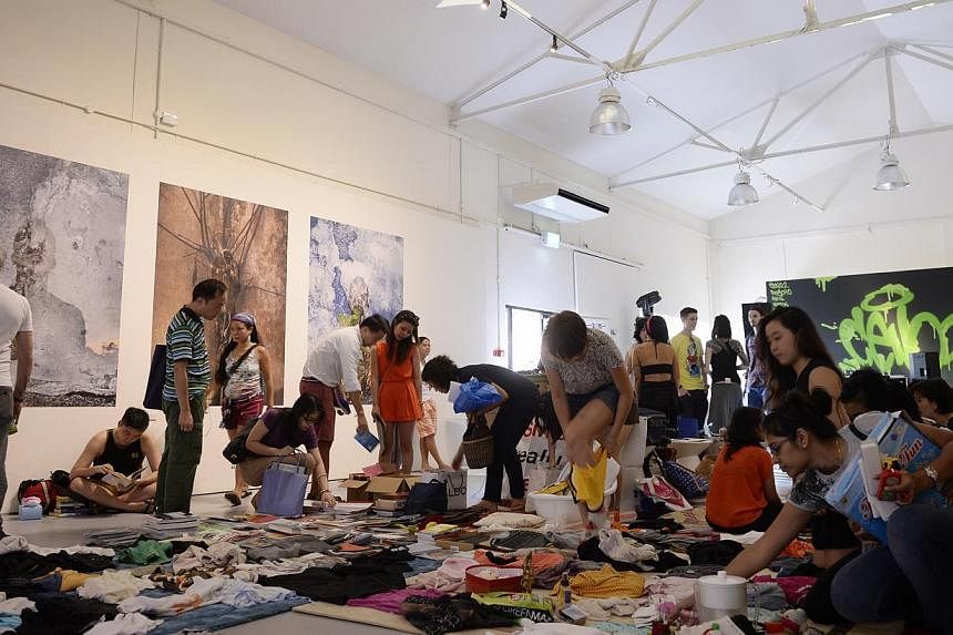 People browse around the Singapore Really Really Free Market during The Mill x WeJungle: Destruction &amp; Rebirth at Jalan Kilang on on Jan 21, 2015. -- ST PHOTO: MARK CHEONG