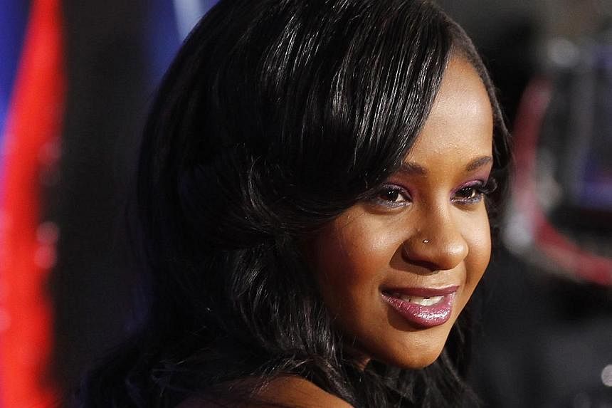 Bobbi Kristina Brown, daughter of the late singer Whitney Houston, poses at the premiere of "Sparkle" in Hollywood, California, in this file photo taken on Aug 16, 2012. She was found unconscious in a bathtub at her home on Saturday and has since bee