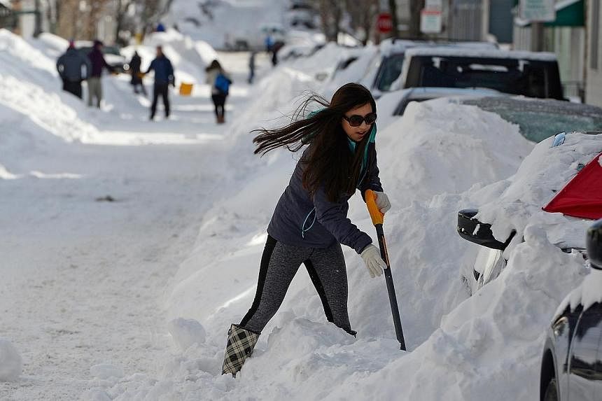 A woman digs her car out from snow in Boston, Massachusetts, USA, on Jan 28, 2015.&nbsp;The north-eastern United States braced for the second major snow storm in a week on Monday, Feb 2, 2015, after a huge winter system dumped more than 30cm of snow 