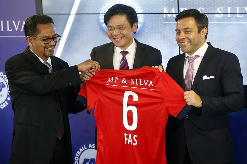 (From left) FAS president Zainudin Nordin and Minister for Culture, Community and Youth Lawrence Wong present a jersey to MP &amp; Silva founding partner Andrea Radrizzani. -- ST PHOTO: KEVIN LIM&nbsp;