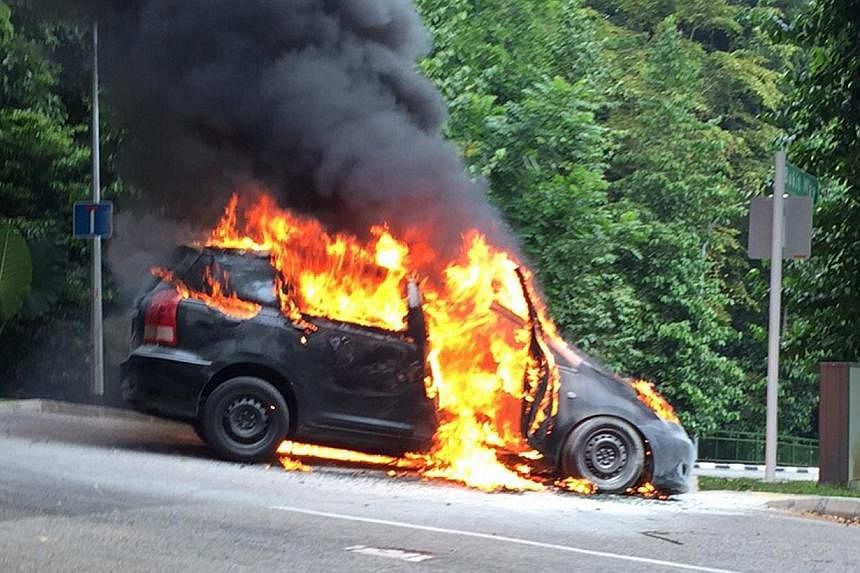 A taxi was destroyed by a fire on Monday morning in Bukit Timah. -- PHOTO: SHIN MIN DAILY