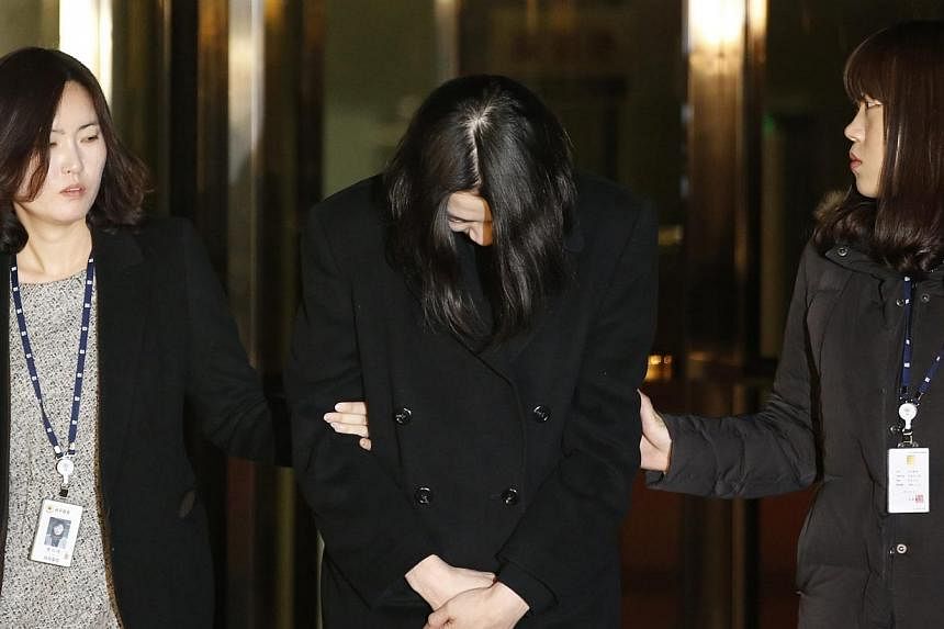 Cho Hyun-ah (centre), also known as Heather Cho, daughter of chairman of Korean Air Lines Cho Yang-ho, leaves for a detention facility after a Korean court ordered her to be detained, at the Seoul Western District Prosecutor’s office on Dec 30, 201