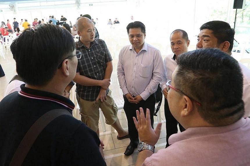 Chief executive of Life Corp Simon Hoo (centre) speaks to residents after the residents' dialogue session on Jan 4, 2015. -- ST PHOTO: NEO XIAOBIN